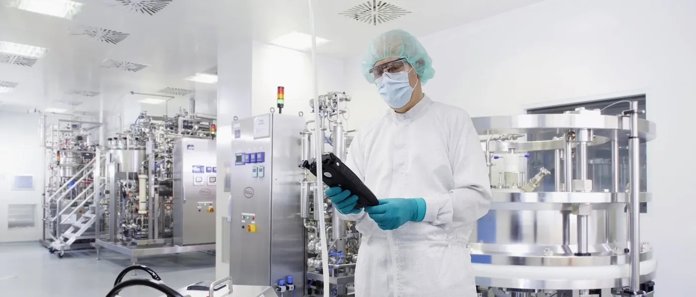 ELI Packaging cleanroom facility with technician monitoring production equipment